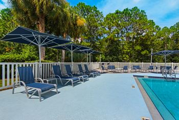 Lounge chairs and seating area with umbrellas.
